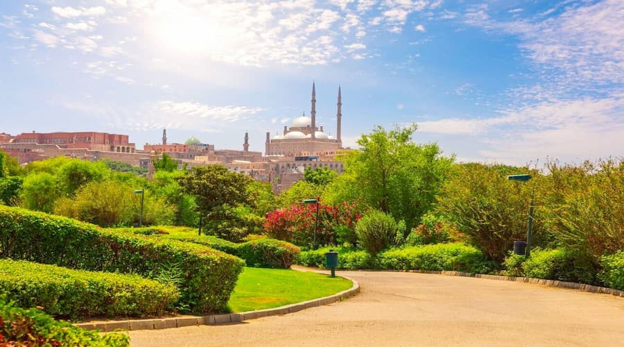 Panoramic view of Al-Azhar Park with landscaped gardens and Cairo skyline in the background